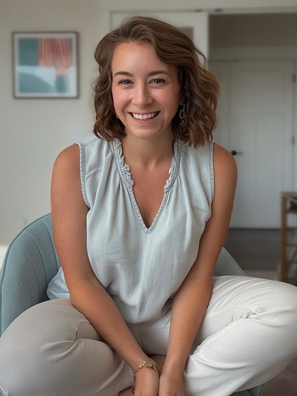 Lauren Howard, founder of Prompt Mama, smiling and seated in a chair